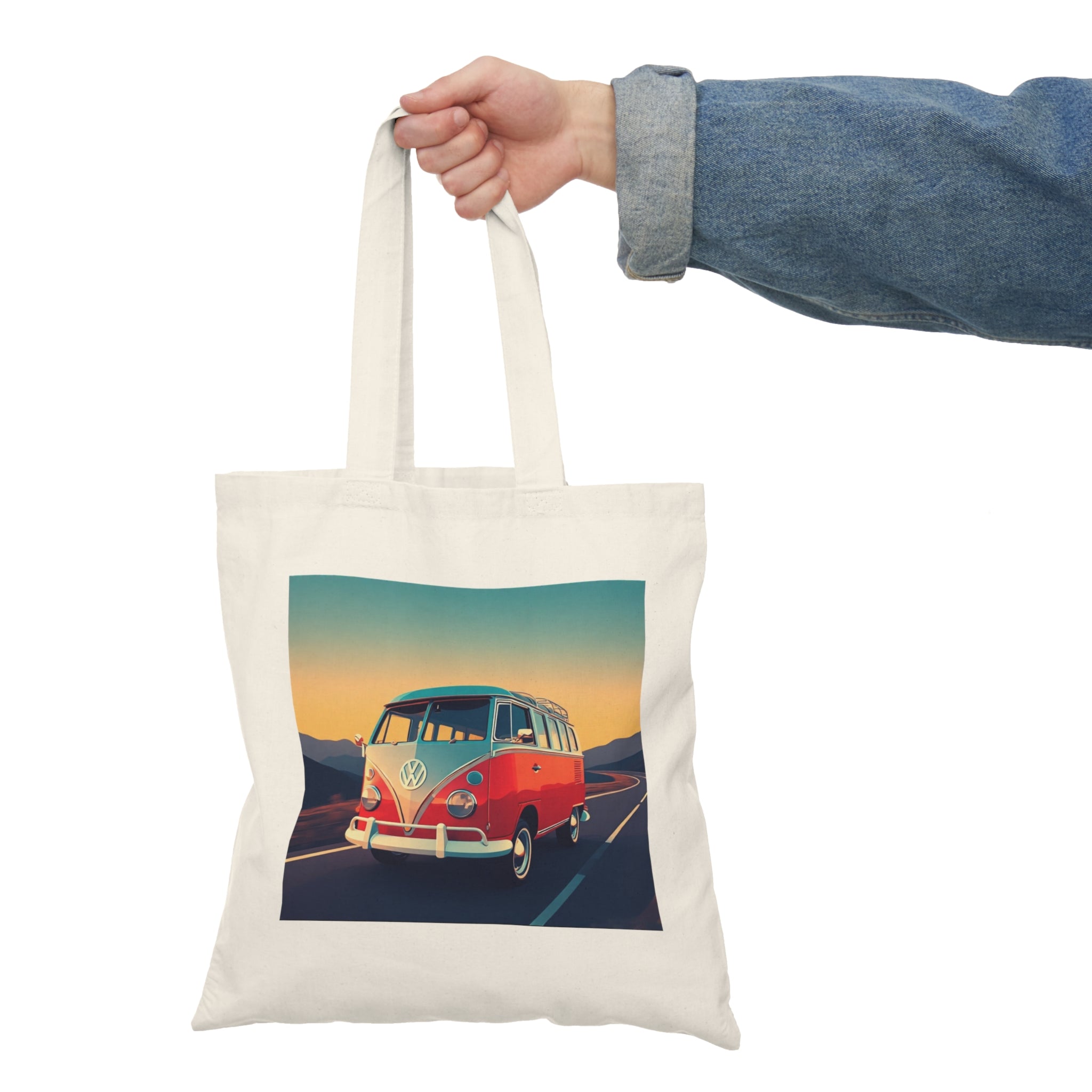 Tote bag with a colorful VW Bus design held by a hand against a white background