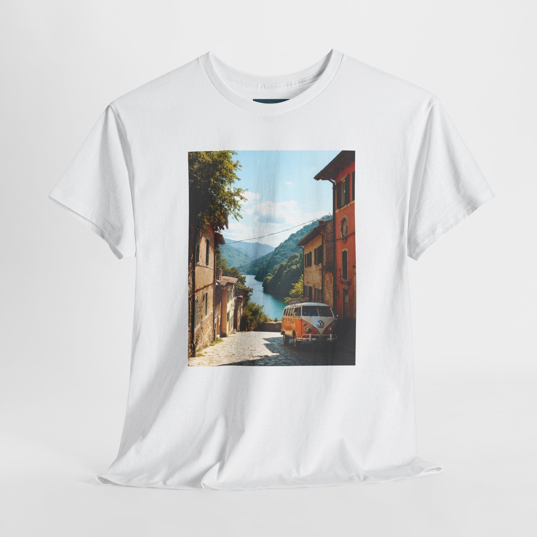 White t-shirt with a printed design of a scenic street with a VW Kombi van and mountains.
