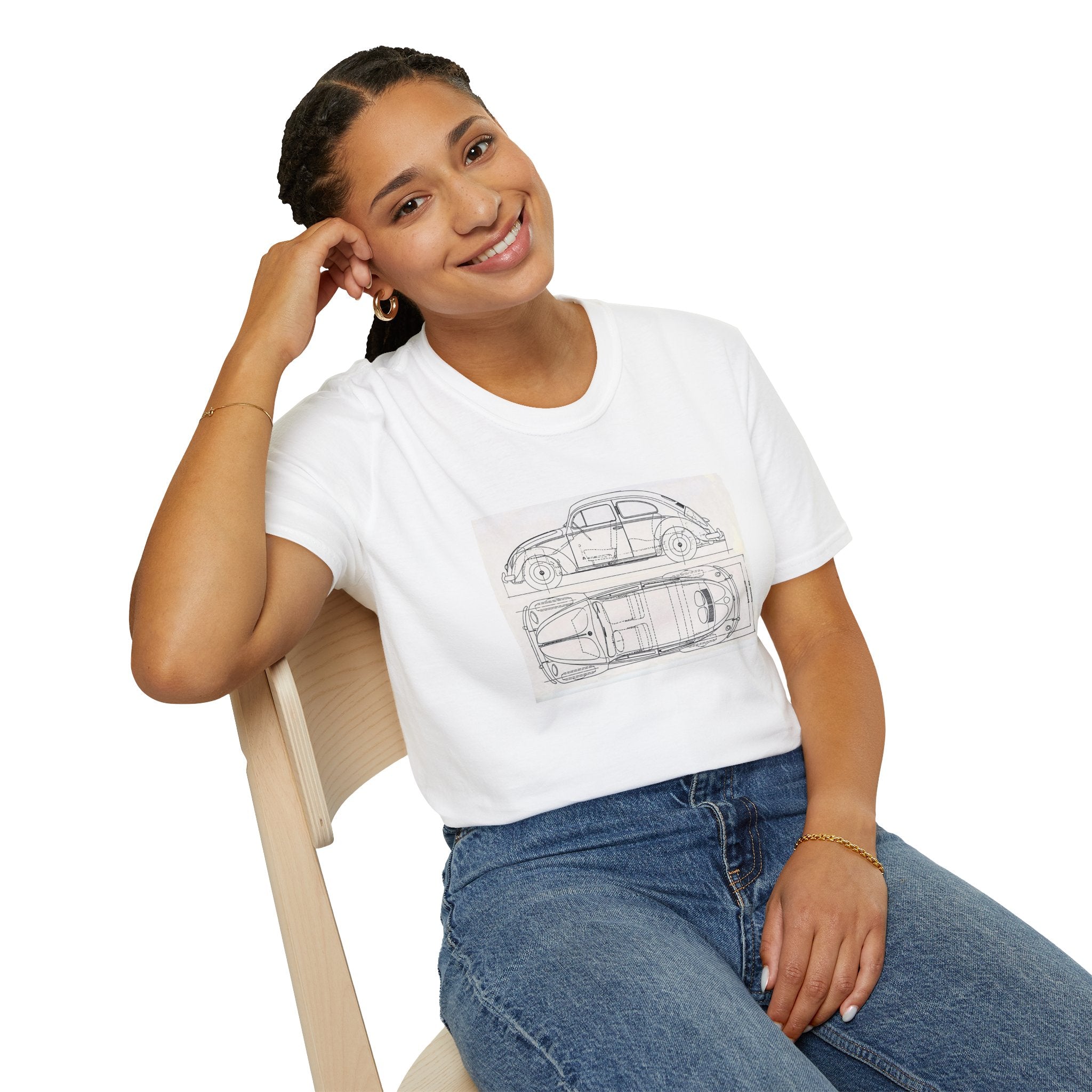 Woman wearing a white t-shirt with a VW Beetle car design and blue jeans, sitting on a chair.