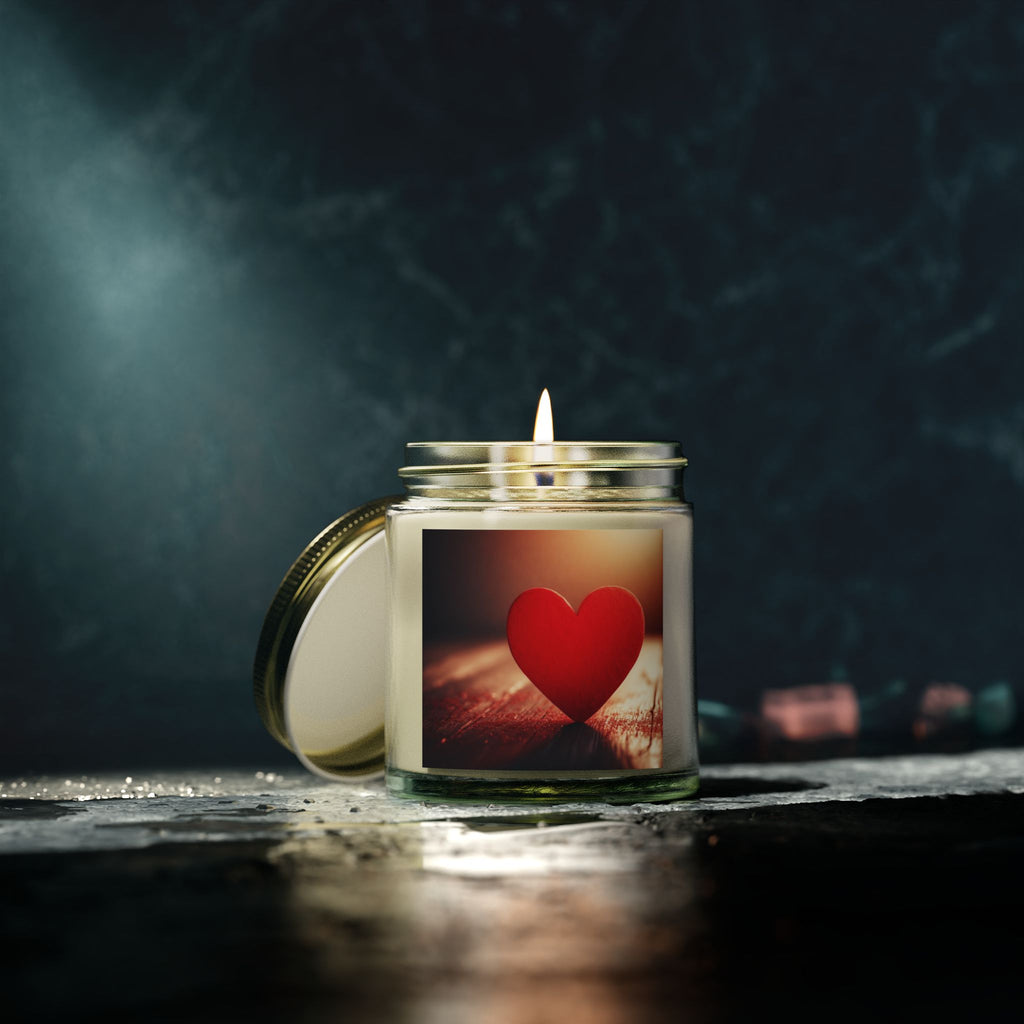 Candle in a glass jar with a red heart design on a dark background
