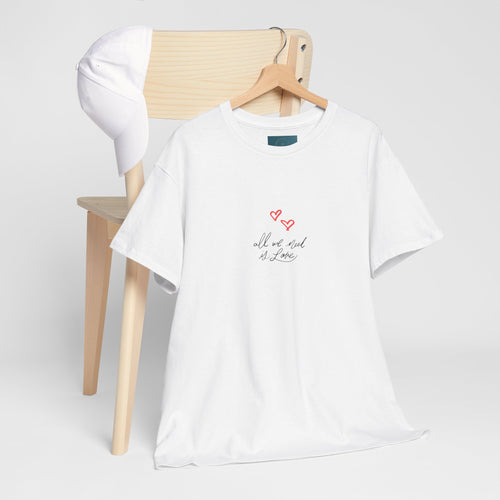 White t-shirt with text and heart design on a wooden chair against a white background