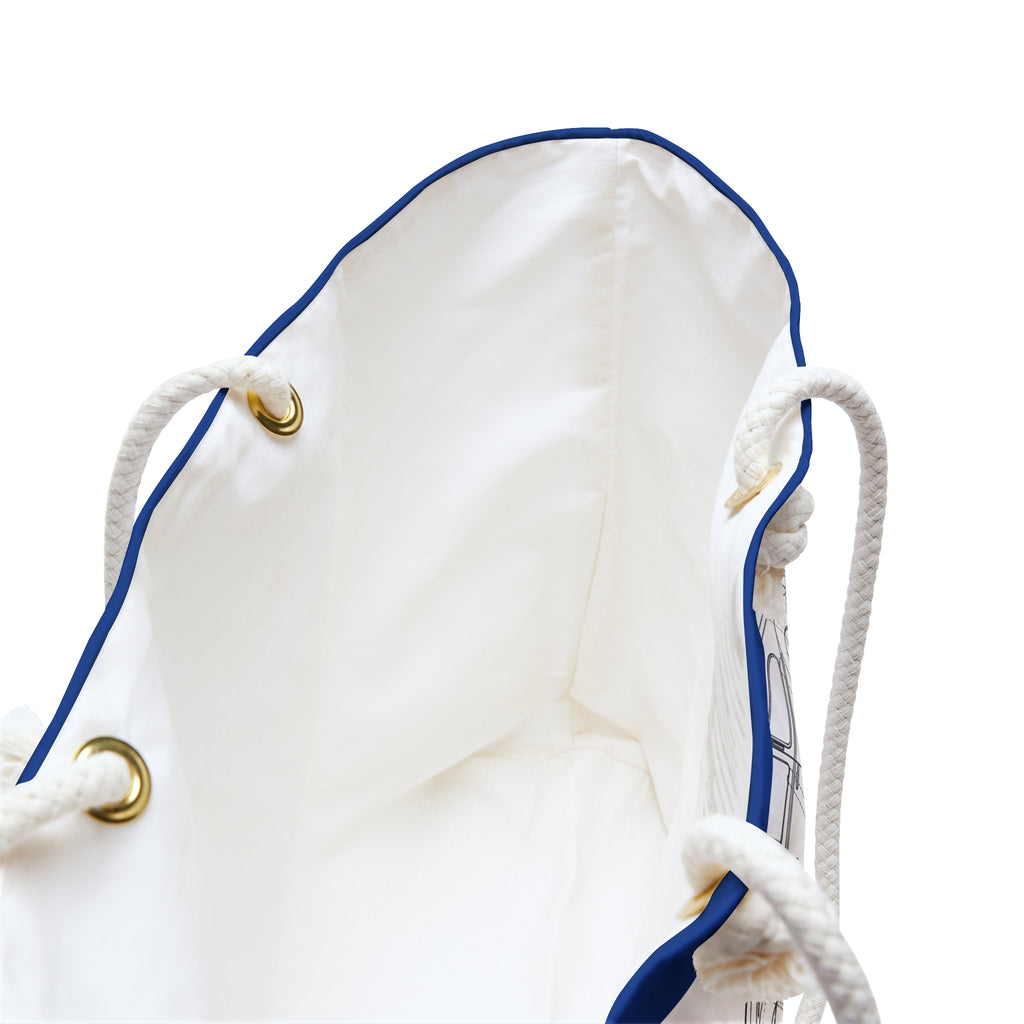 White drawstring bag with blue trim and gold metal loops on a white background