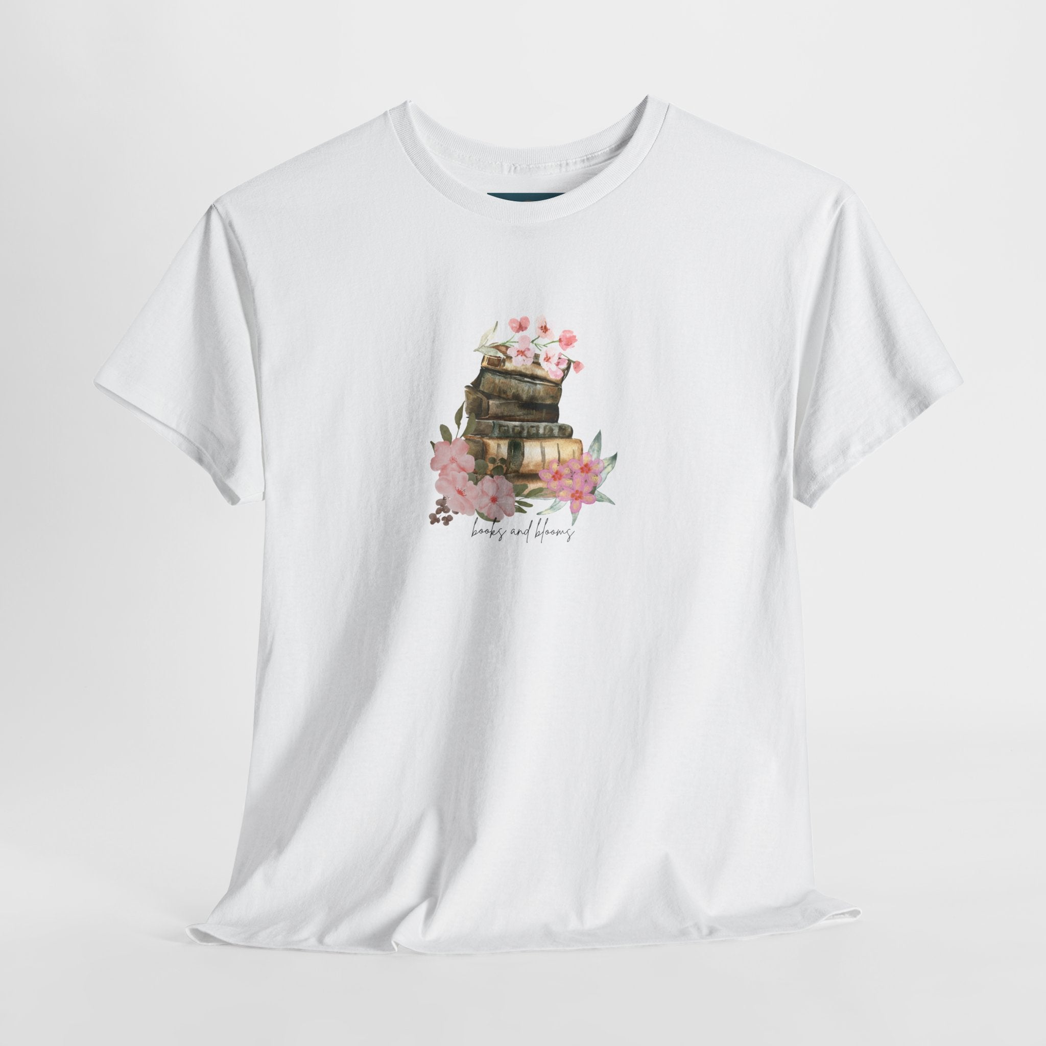 White t-shirt with a graphic of books and flowers on a white background