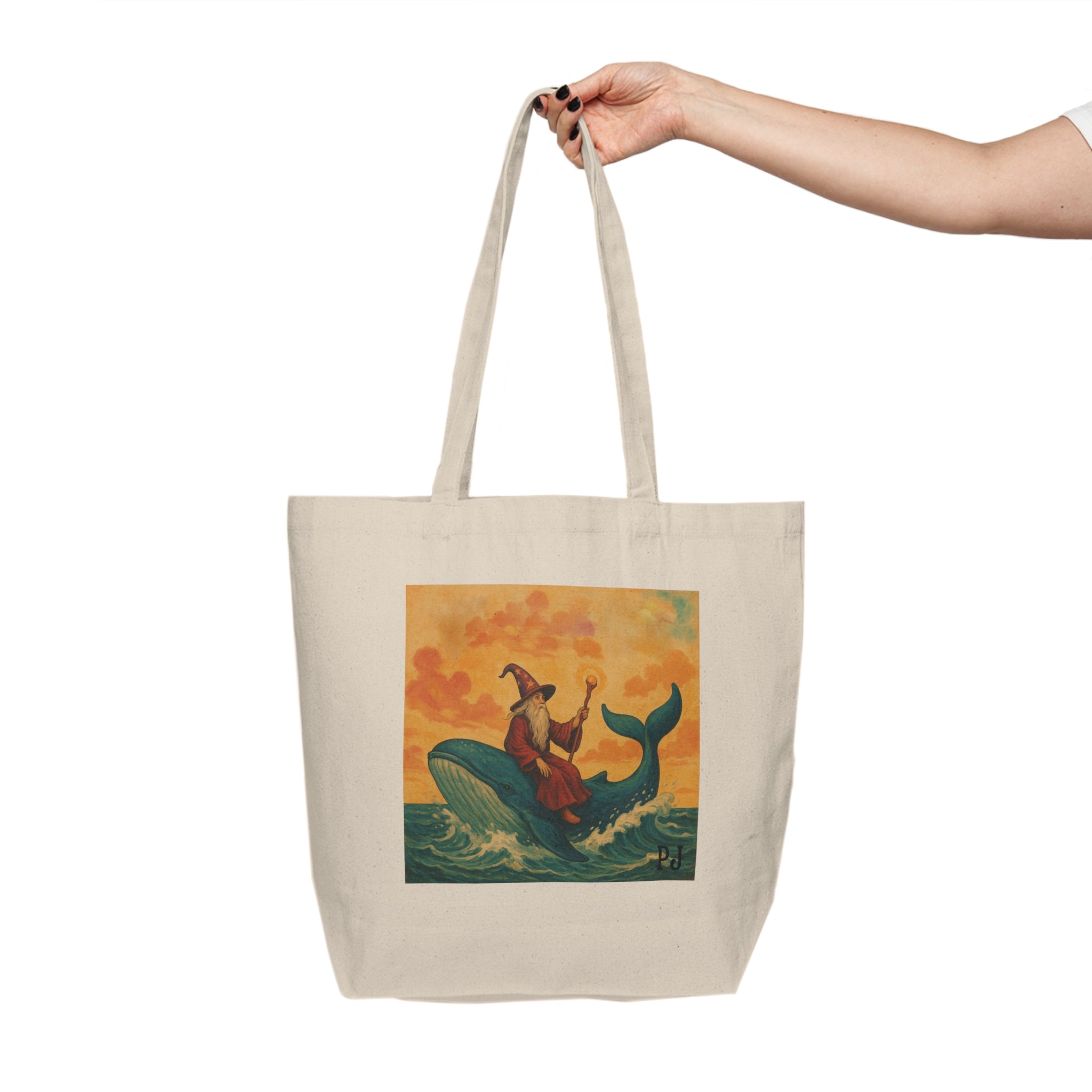 Tote bag with a wizard on a whale design held by a hand on a white background