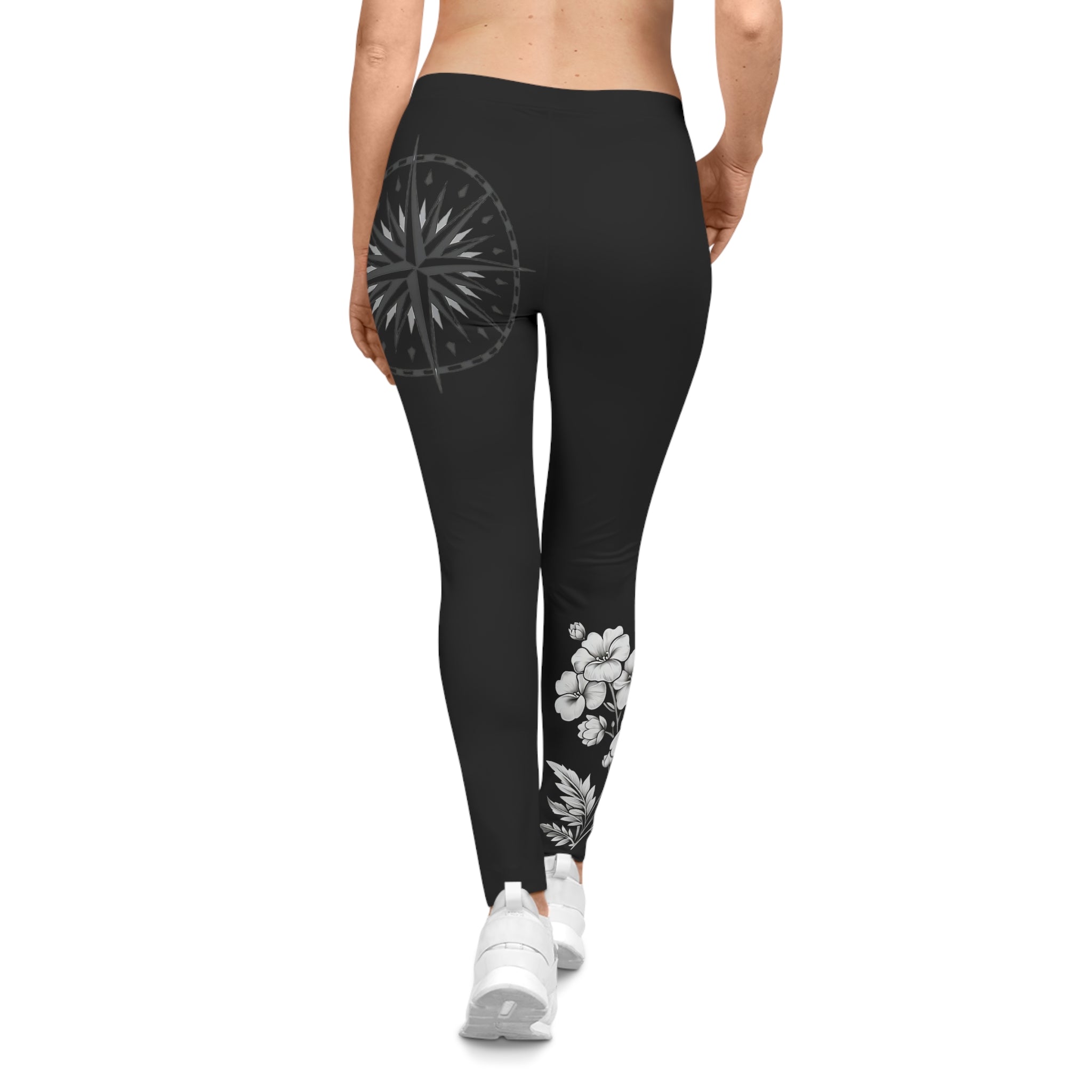 Black leggings with floral designs on a white background