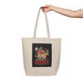 Beige tote bag with floral design and 'GARDEN' text on a white background