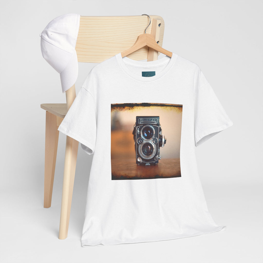 White t-shirt with a camera graphic on a wooden chair against a white background