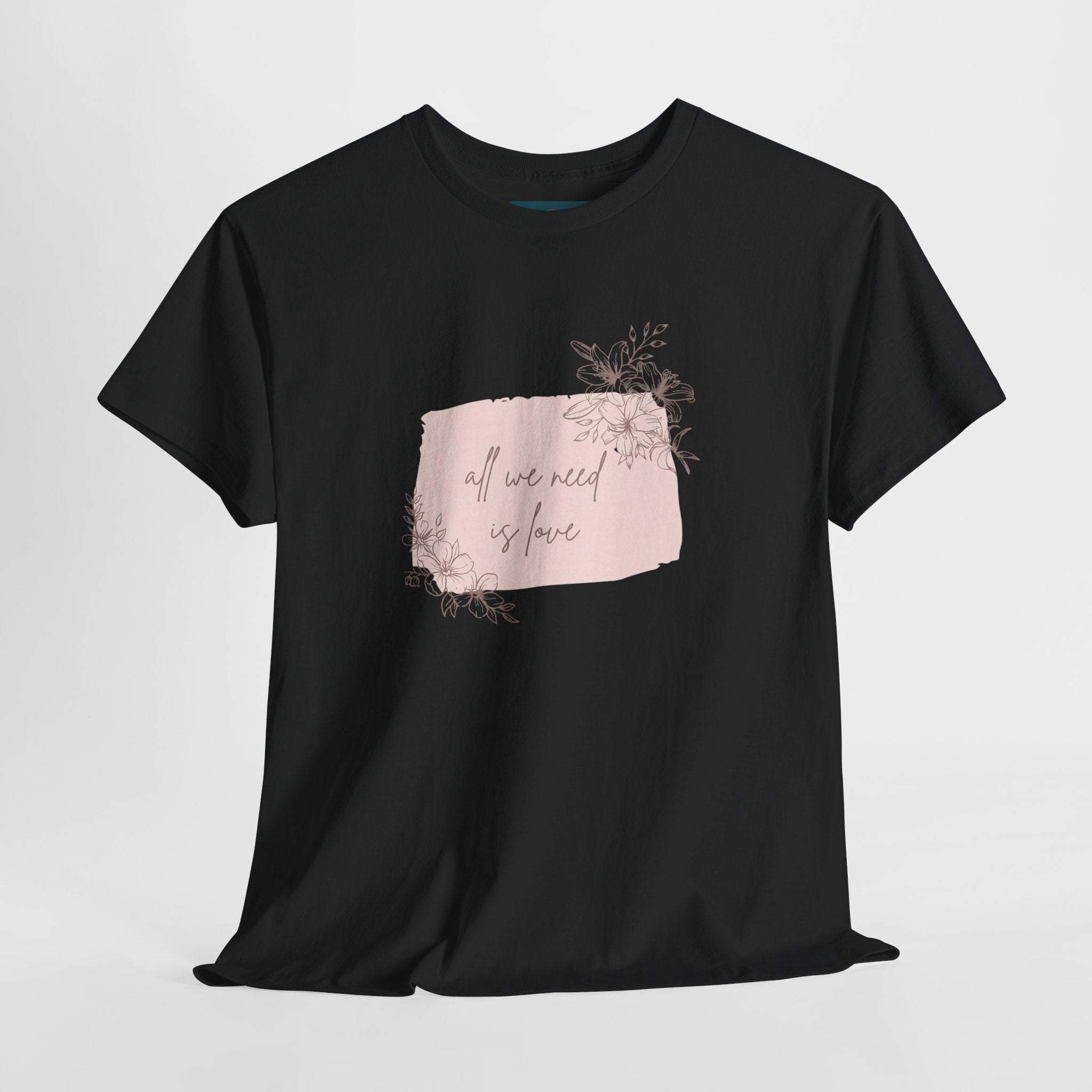 Black t-shirt with a pink graphic and text on a light gray background