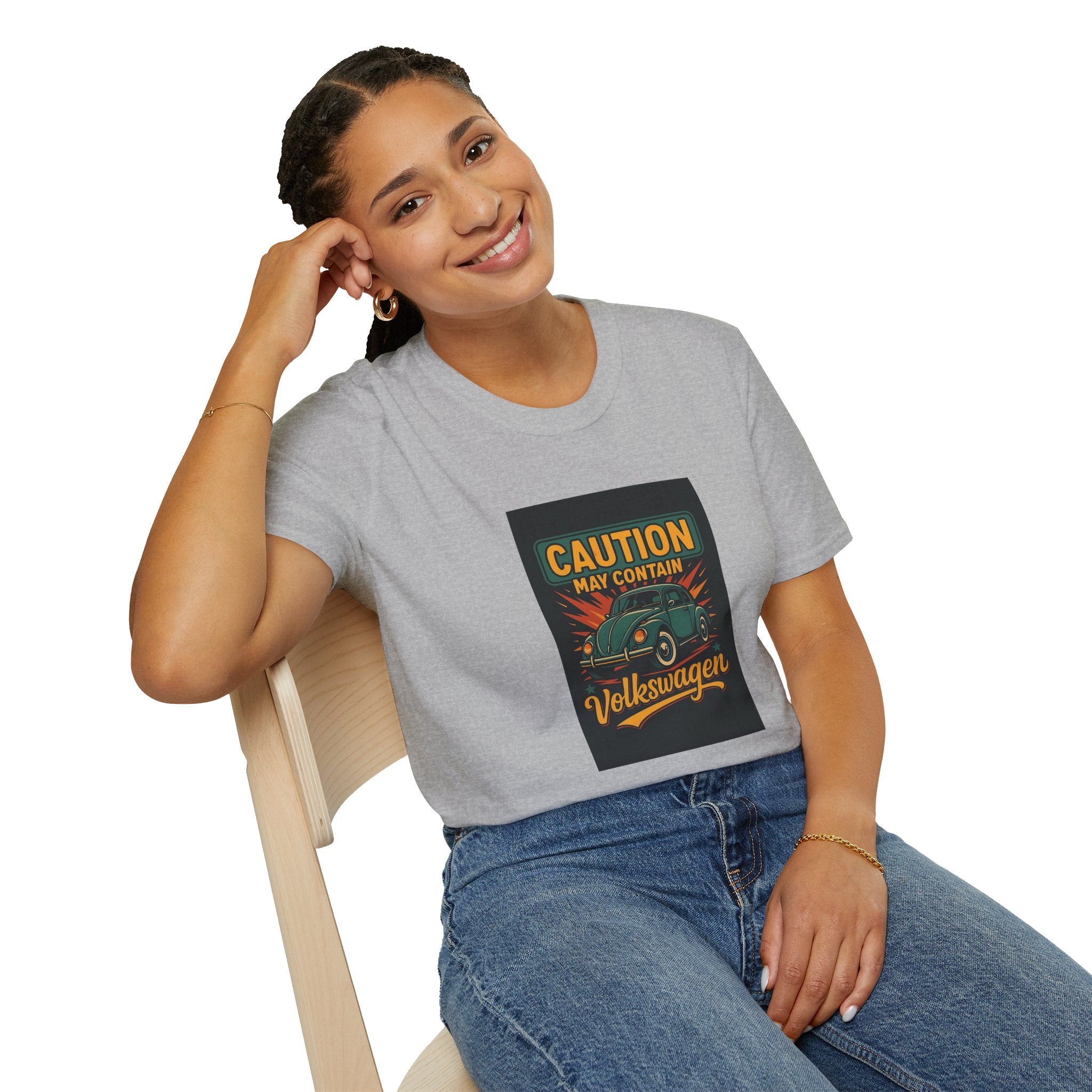 Person wearing a gray t-shirt with a graphic design sitting on a chair.