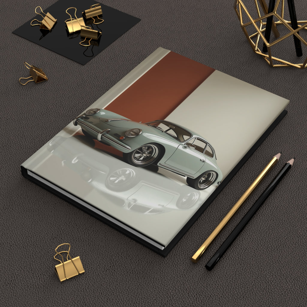 Notebook with porsche car illustration on a dark surface with office supplies