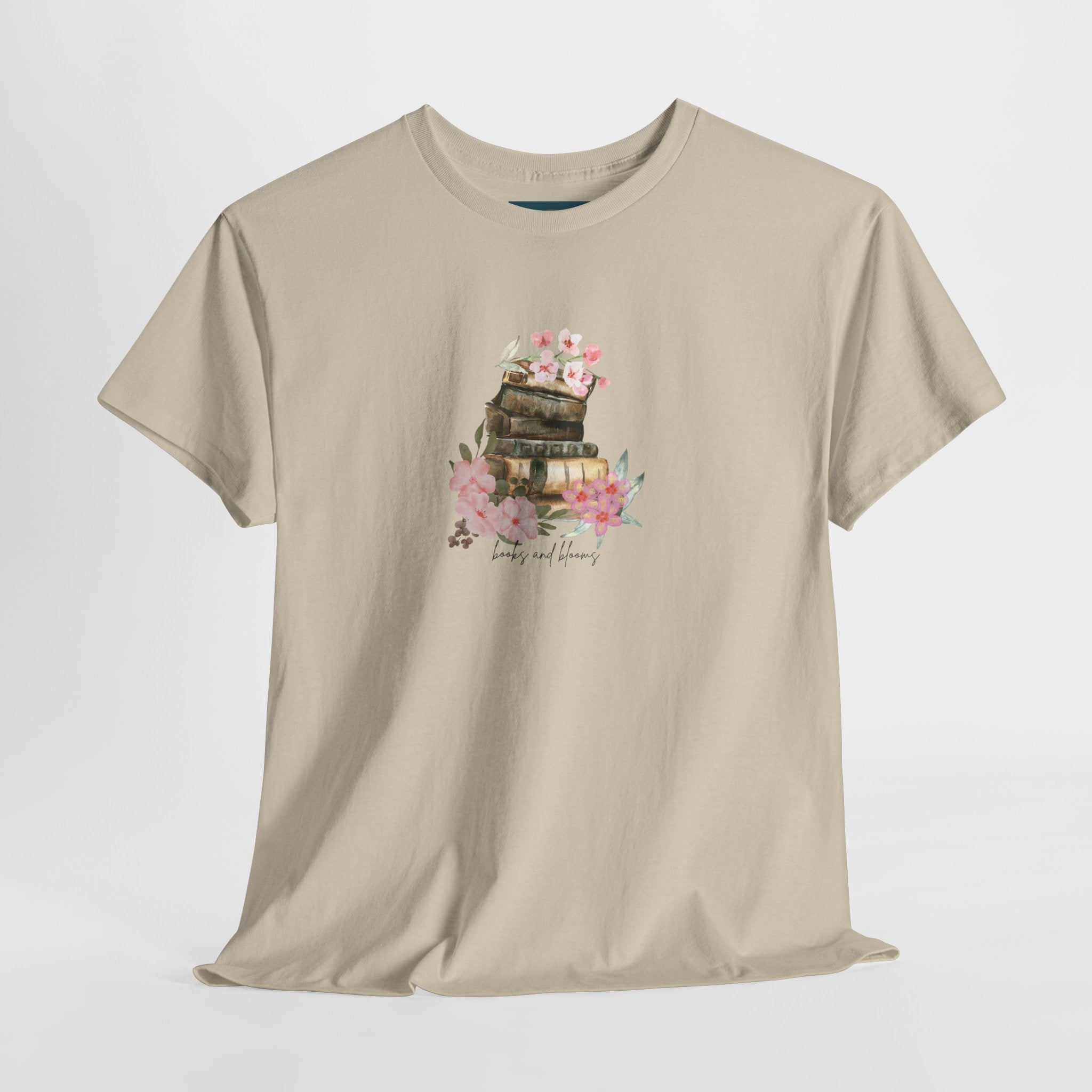 Beige t-shirt with a graphic design of a books and flowers on a white background