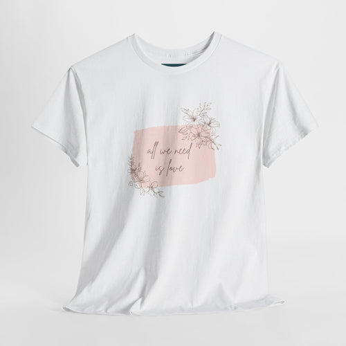 White t-shirt with a pink floral graphic and text on a light gray background