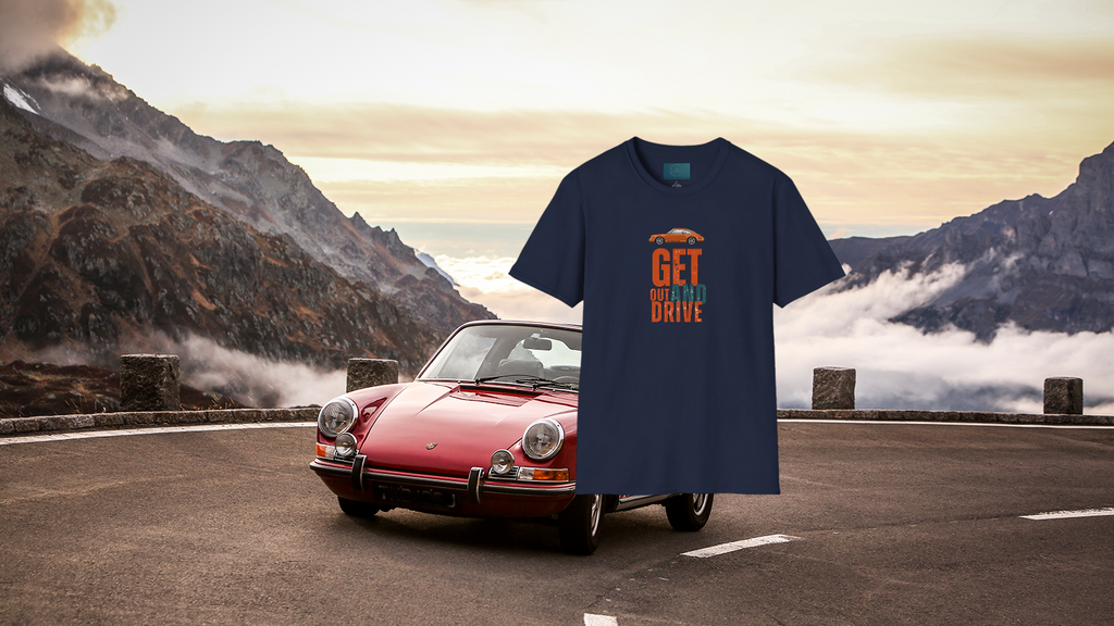 Blue t-shirt with 'GET OUT AND DRIVE' text on a porsche 911 car with mountainous landscape in the background