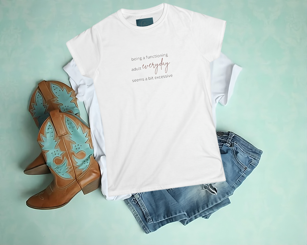 White t-shirt with text, brown cowboy boots, and denim shorts on a light green background