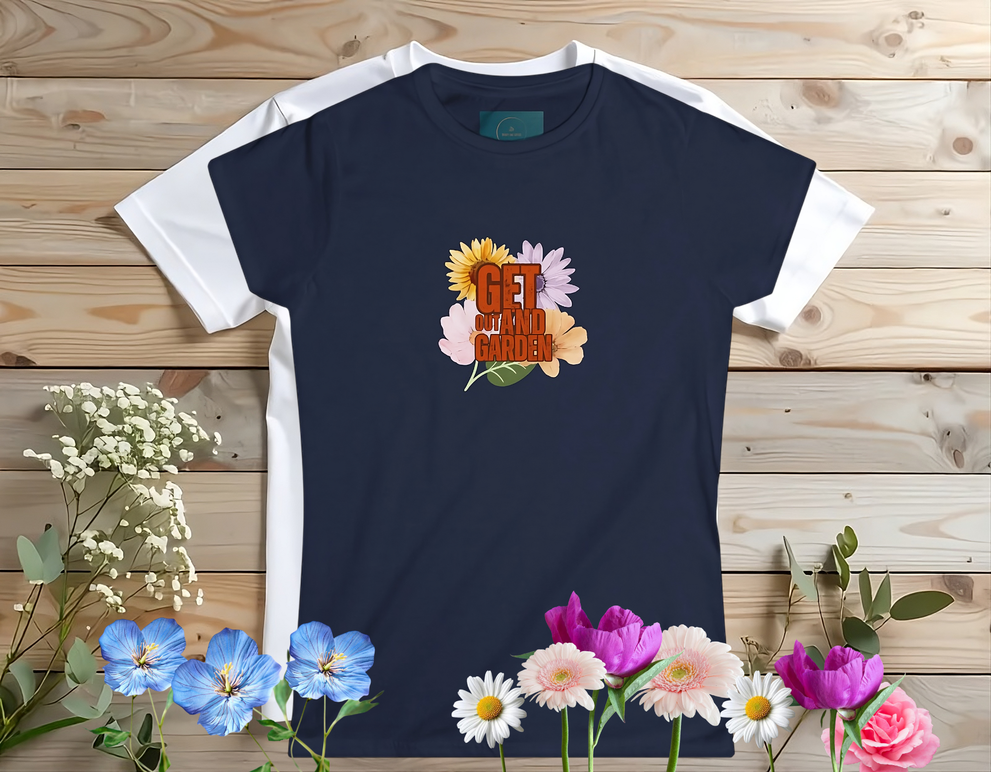 Navy blue t-shirt with floral design and text on a wooden background