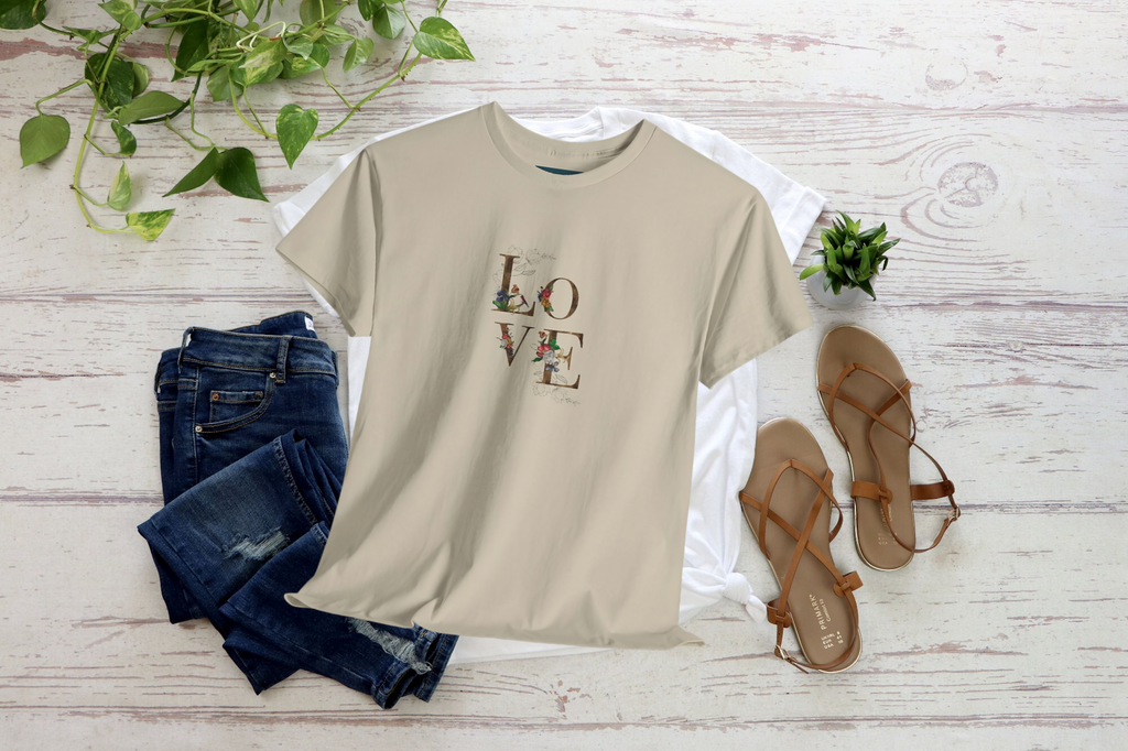 Beige sand t-shirt with 'LOVE' print, blue jeans, and brown sandals on a light wooden surface.