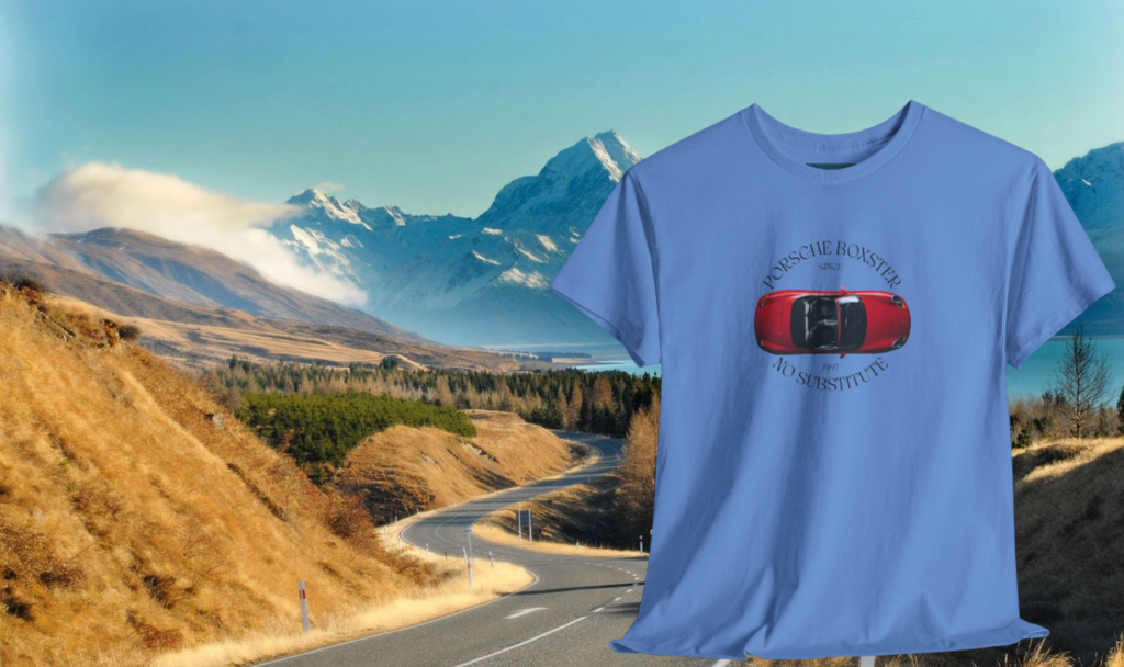 Blue t-shirt with a red and black graphic design over a scenic mountain road background