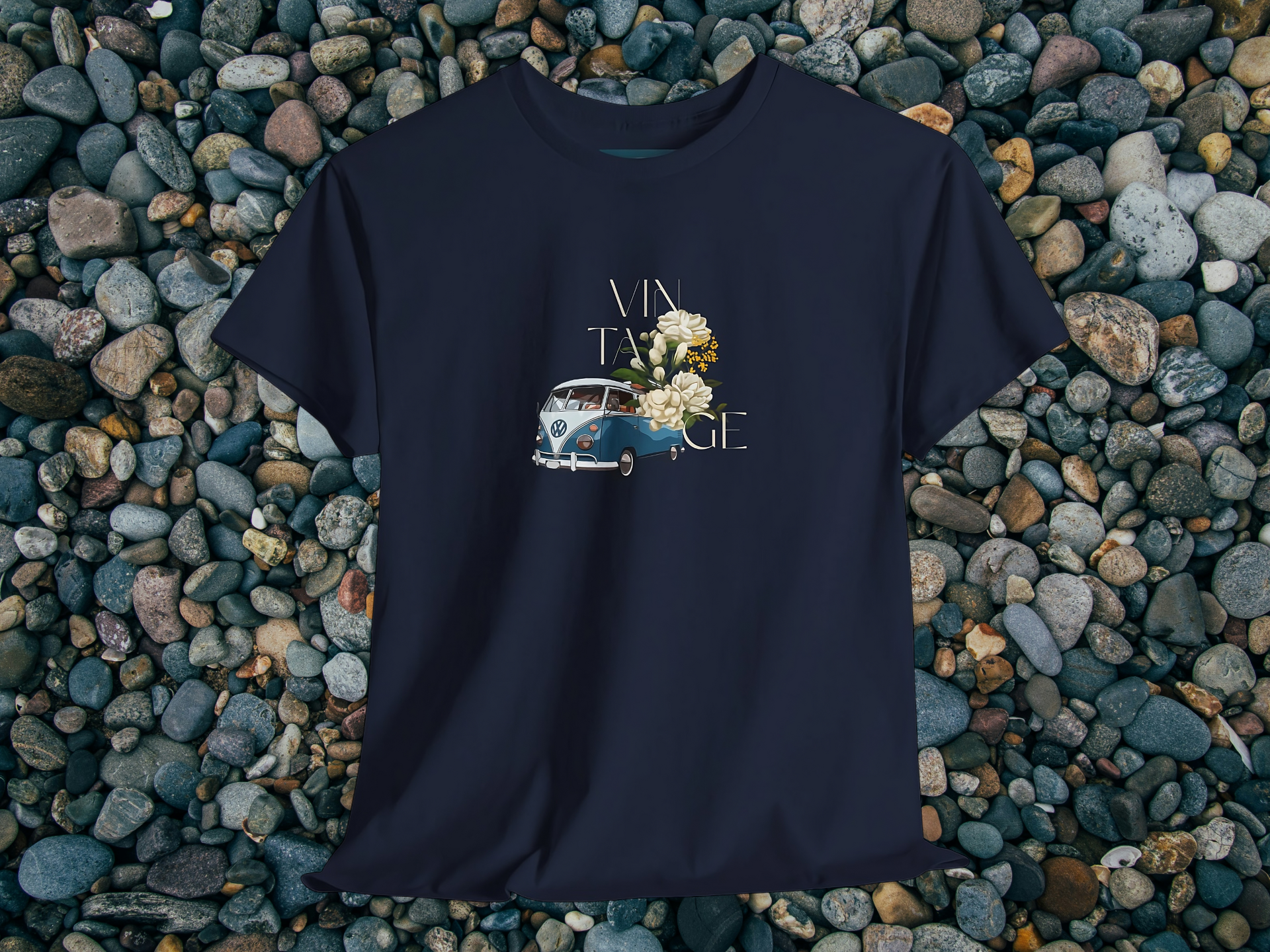 Navy blue t-shirt with vintage vw bus and floral design on pebbles background
