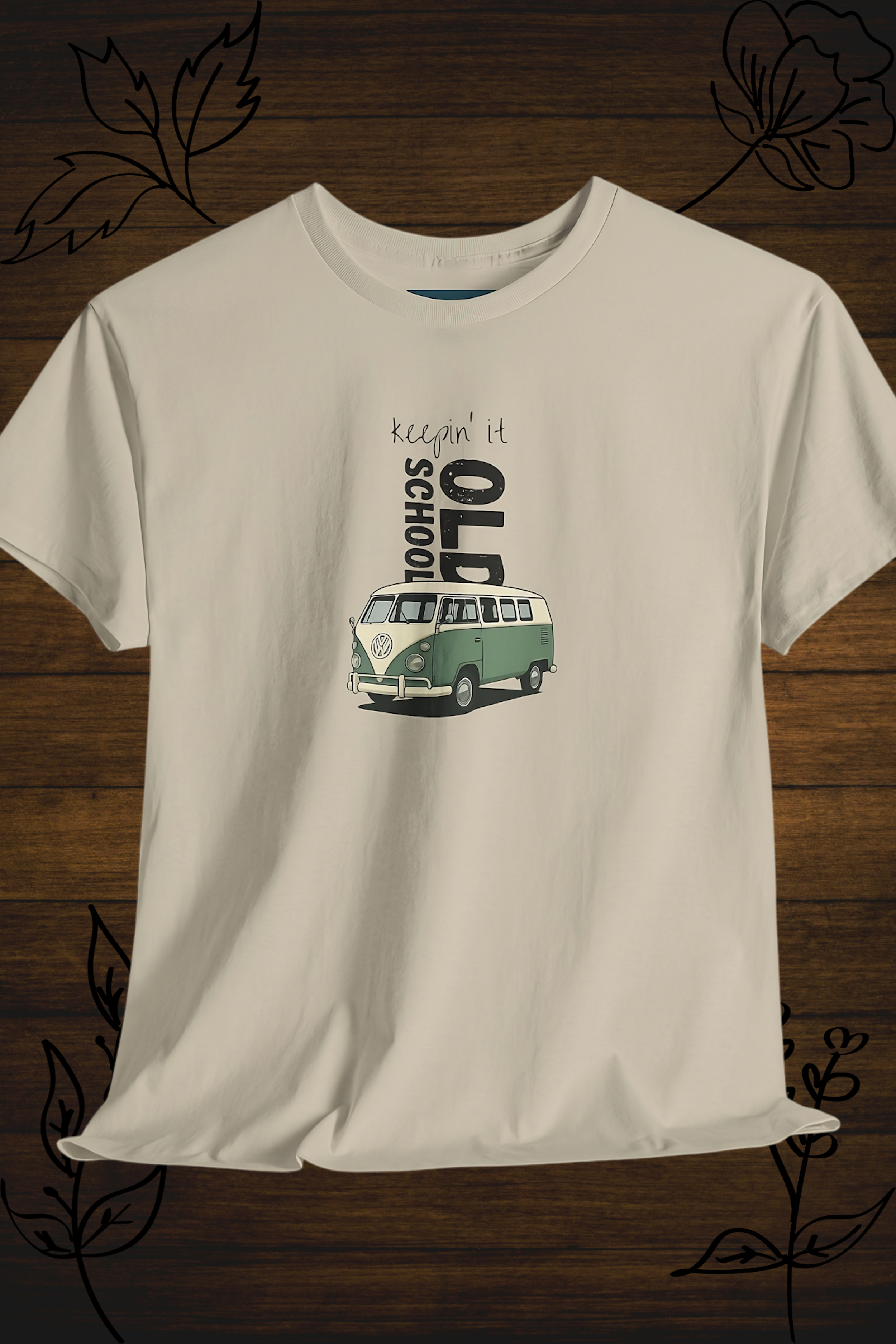White t-shirt with a graphic of a vintage vw kombi and text on a wooden surface